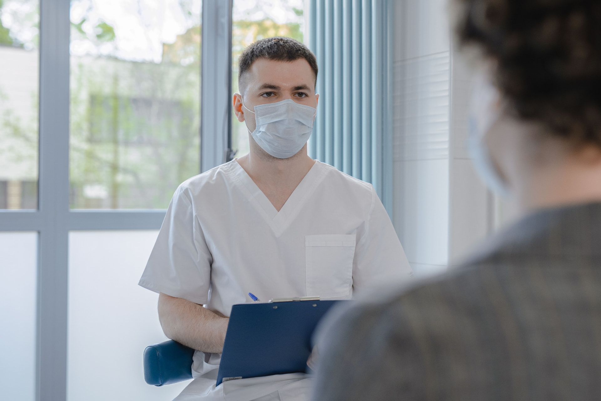 Clinician in a follow-up consultation with a patient
