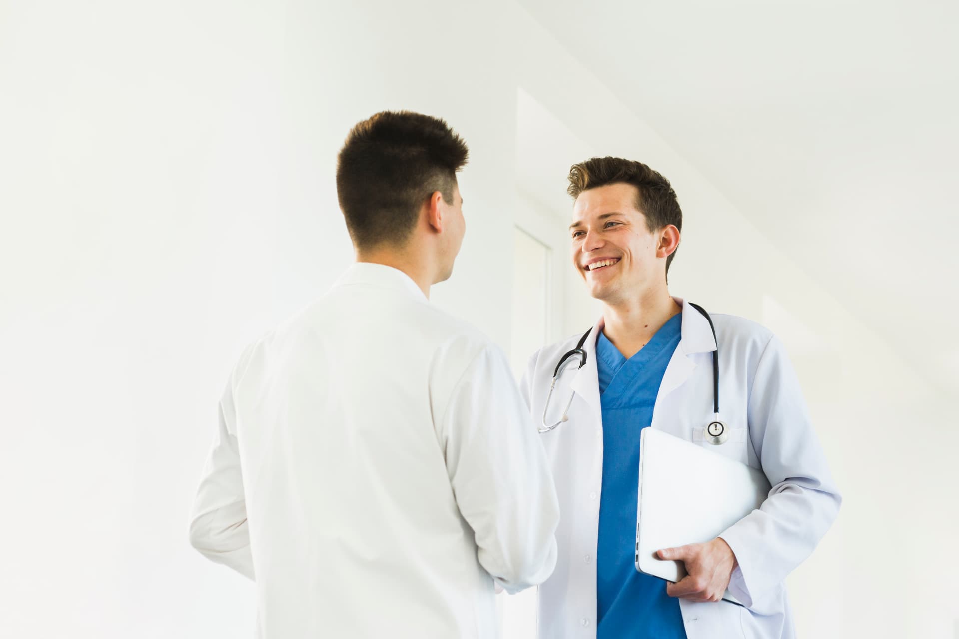 Doctor greeting a patient with a friendly handshake at the clinic